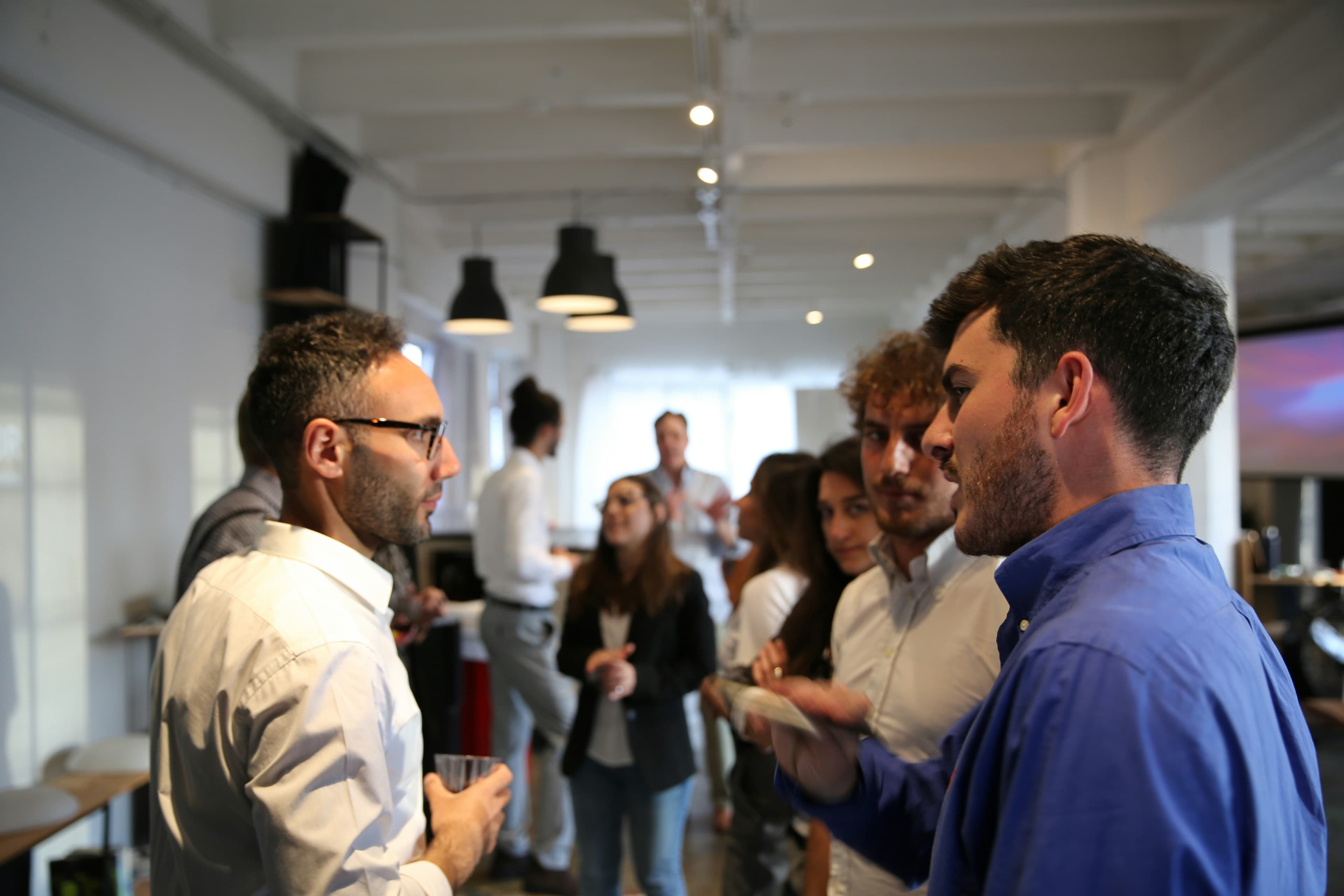 A founder in conversation with a professional adviser in a modern workspace
