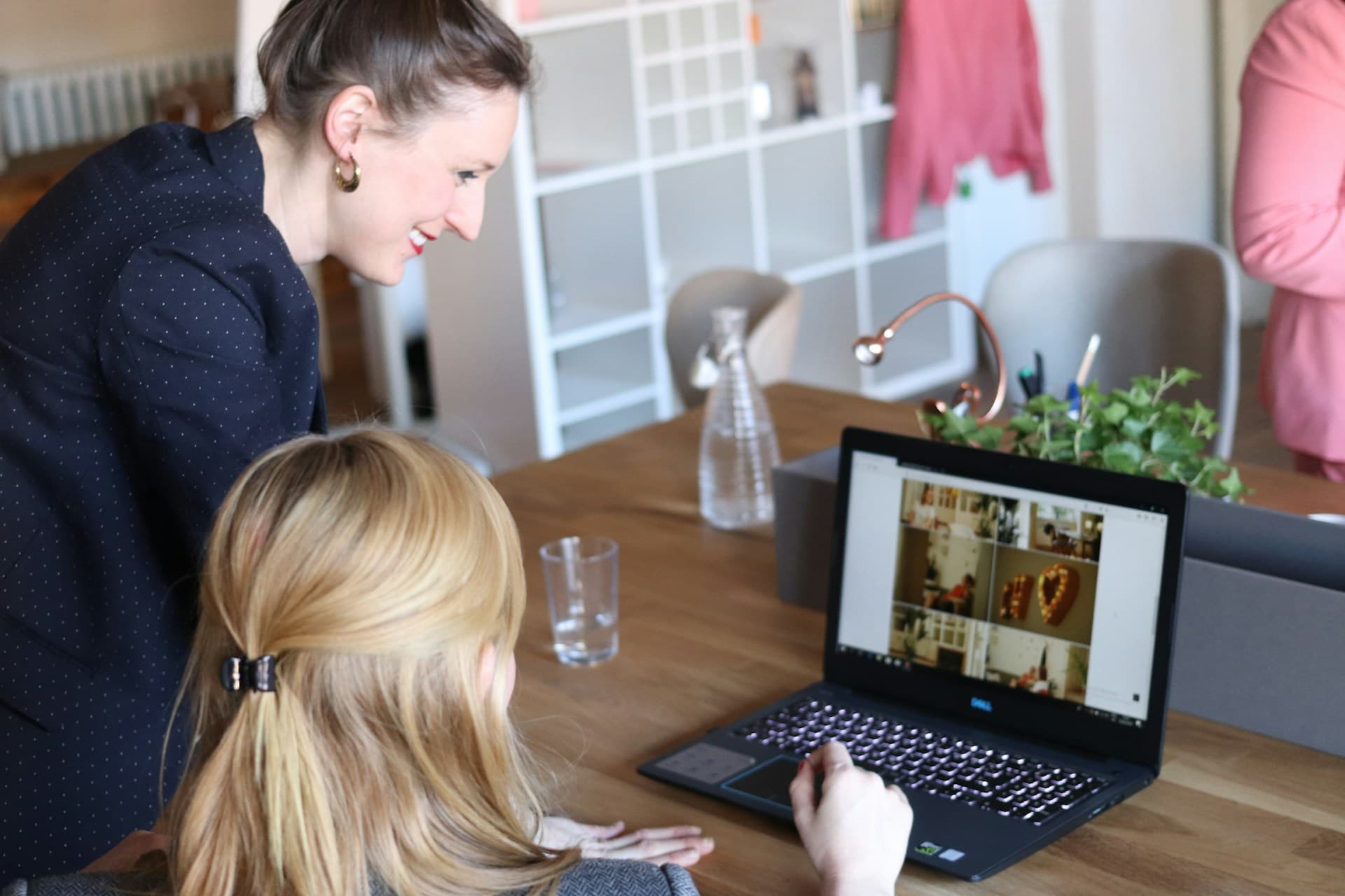 Two professionals in a one-to-one mentoring conversation at a workspace