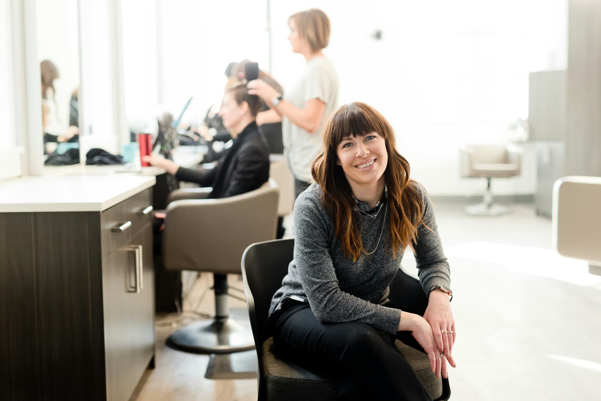 A confident professional standing in a modern workspace
