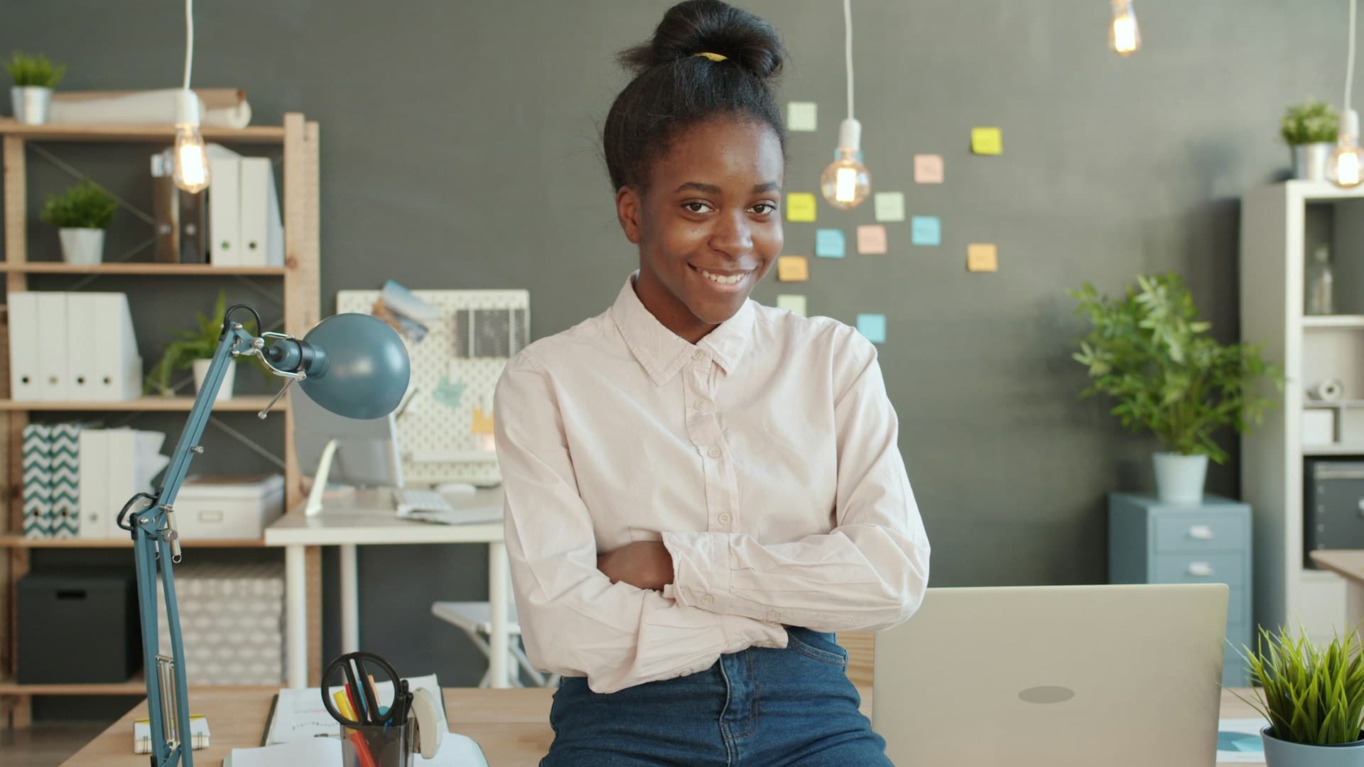 A focused entrepreneur working at a laptop in a creative workspace