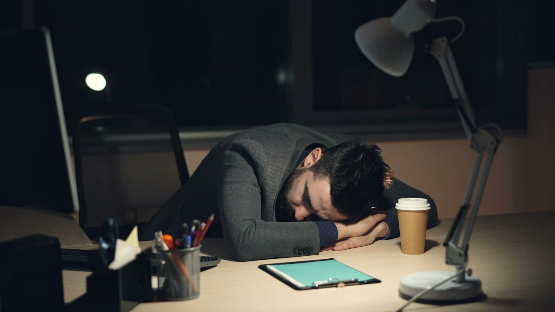 An exhausted founder collapsed on their desk late at night