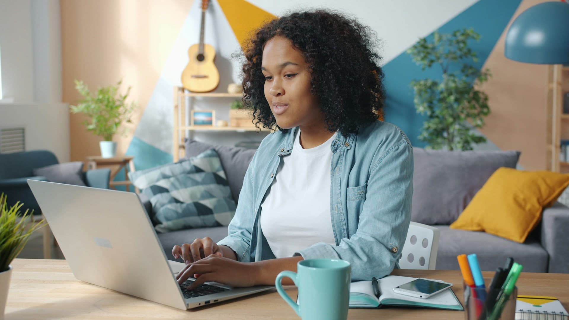 A focused founder working at a laptop in a home office