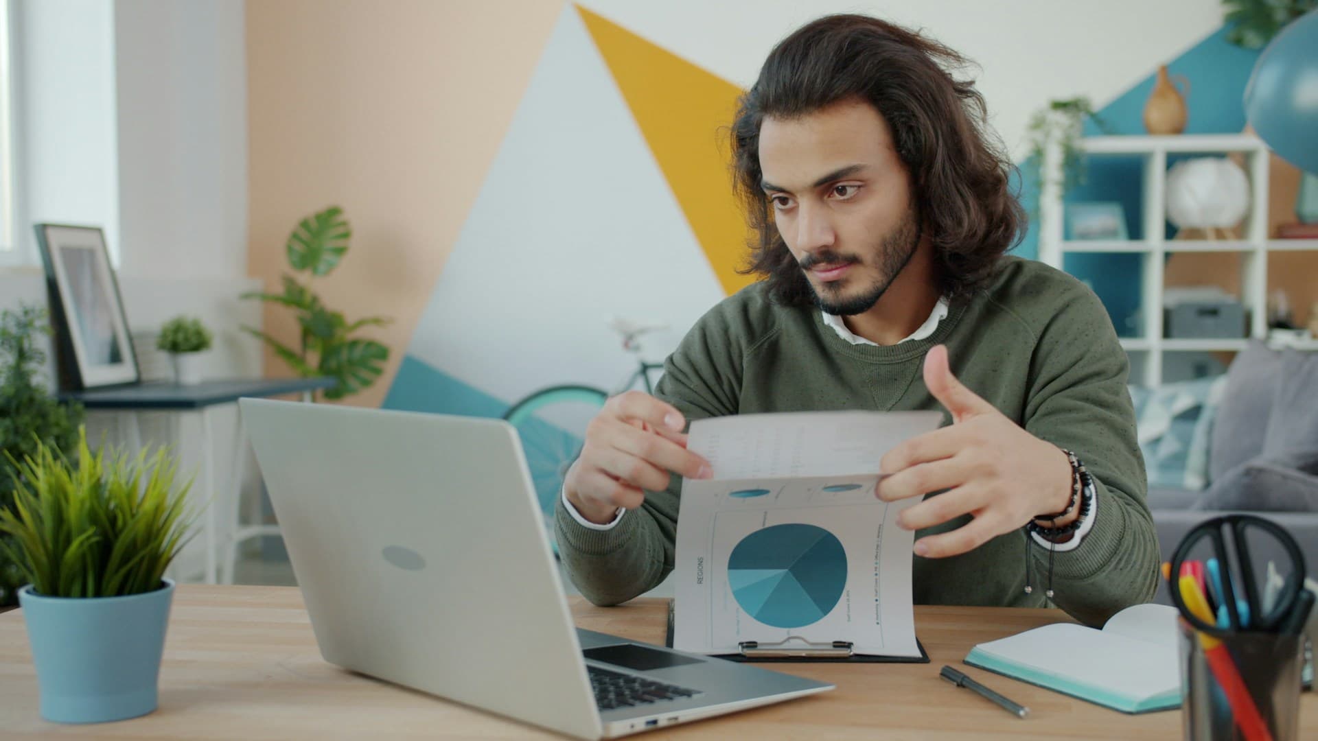 A founder reviewing business charts and data at a laptop